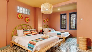 A room with two beds, a woven hanging light fixture, and patterned floor tiles. - Por Aqui Stay & Dine (Yogyakarta)