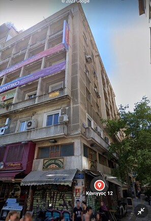 Stylish urban building with shops and balconies, offering a convenient location.