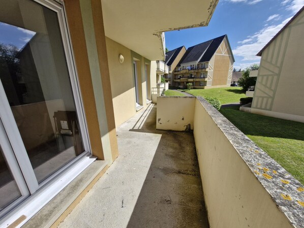 Enjoy the expansive balcony with a sliding glass door leading to a spacious interior.