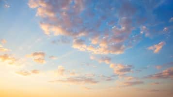 A clear sky with scattered clouds.