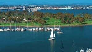 A marina with boats and a bridge in the background.