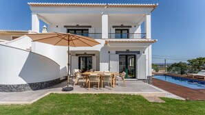 A two-story house with a pool, outdoor seating, and a view of the landscape. - Villa Maya Luxurious House With Pool by LovelyStay (Praia da Luz)
