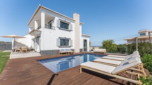 A two-story house with a swimming pool, a wooden deck, and outdoor furniture. - Villa Maya Luxurious House With Pool by LovelyStay (Praia da Luz)