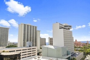 A high-rise hotel with multiple floors, a parking garage, and a view of the ocean. - Partial ocean view, 13th FL, Renovated, Free Parking (Honolulu)
