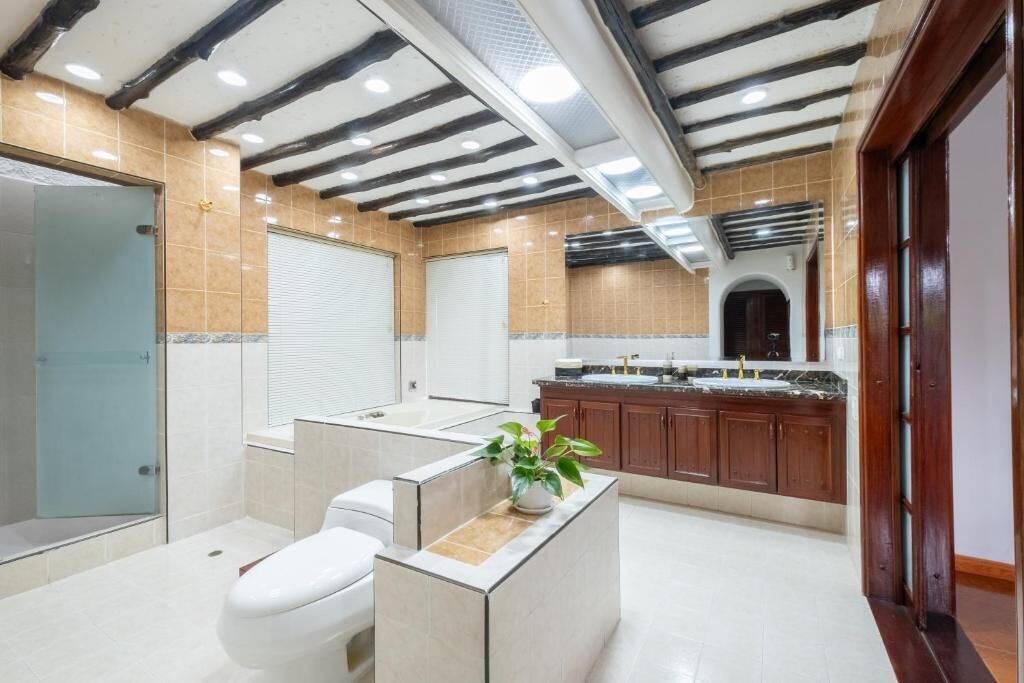 A modern bathroom with a shower, toilet, and sink area.