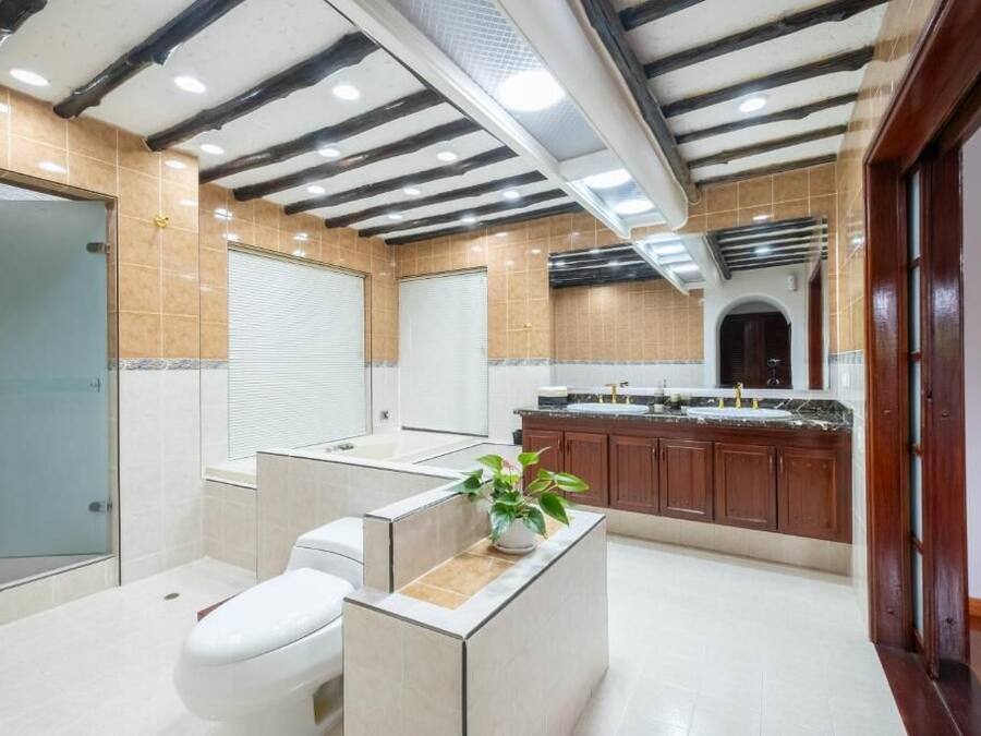 A modern bathroom with a shower, toilet, and sink area.
