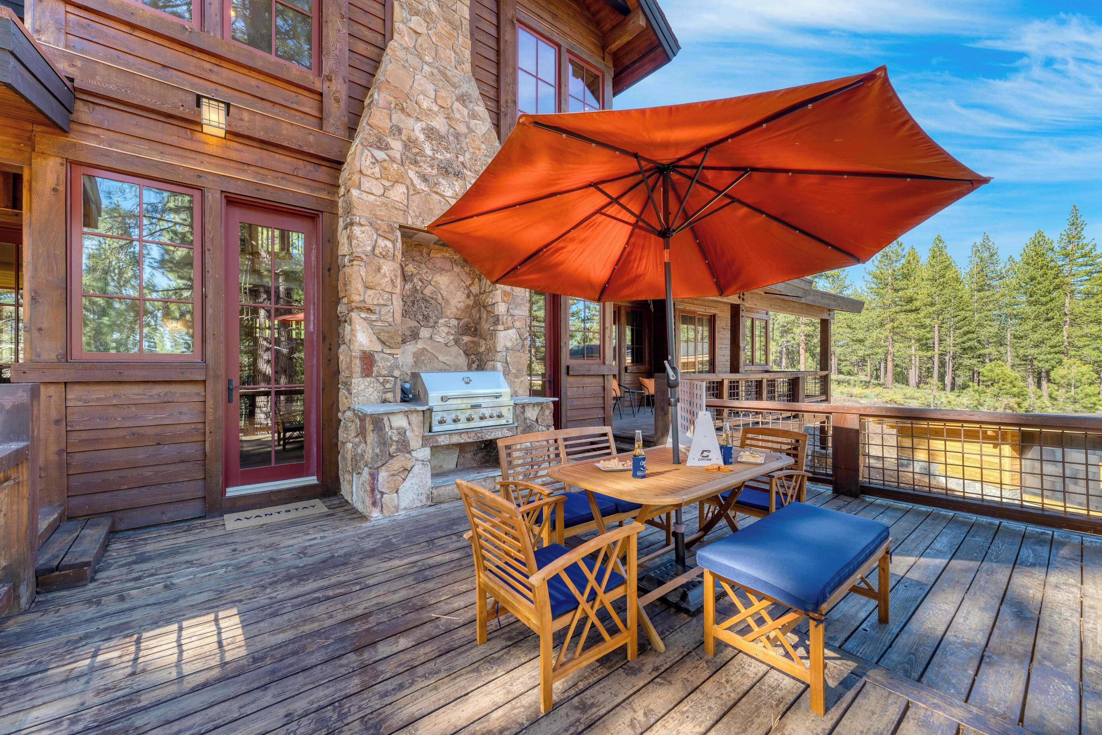 A wooden deck with outdoor furniture and a barbecue grill.
