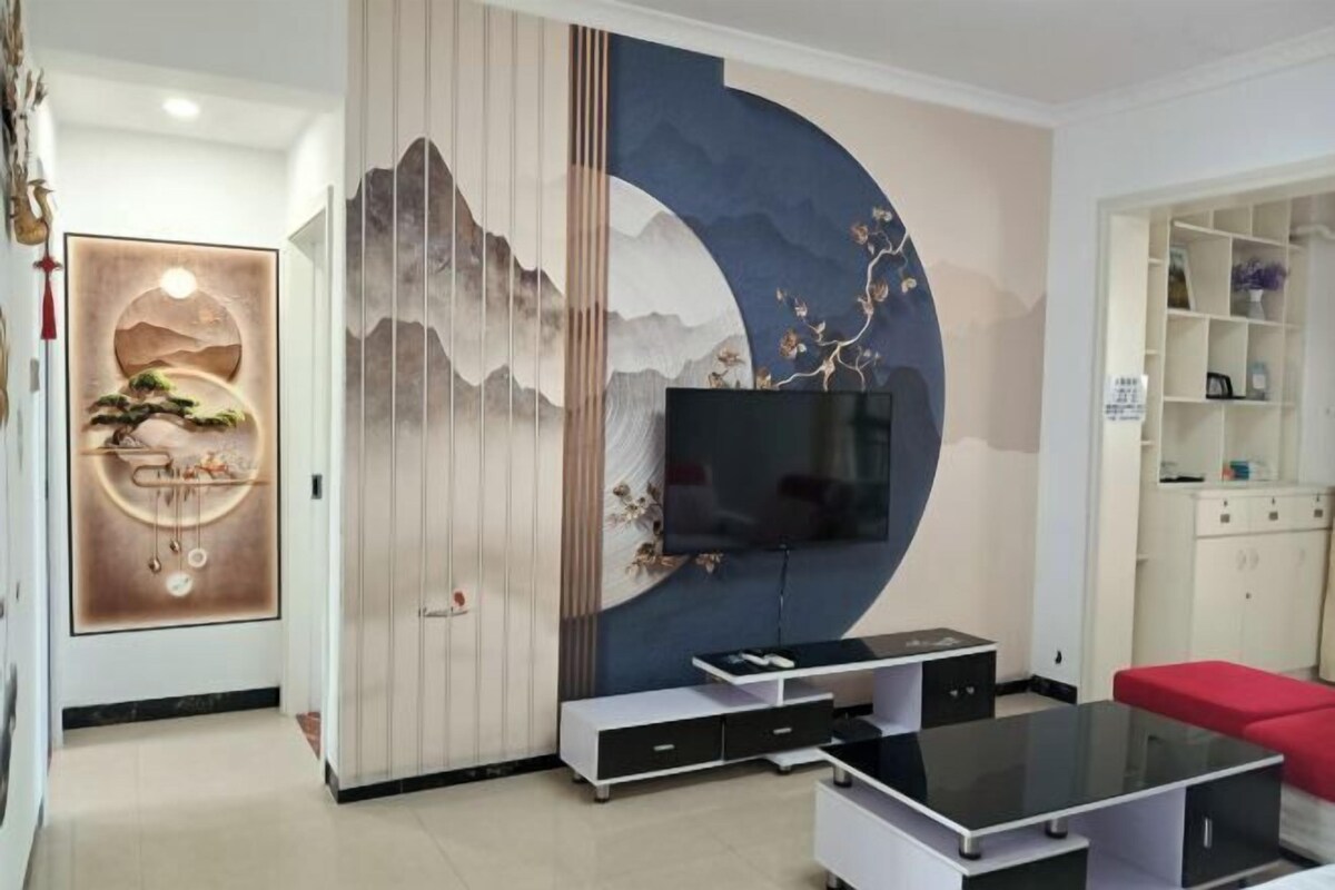 A modern living room with a TV, a sofa, and a cabinet.