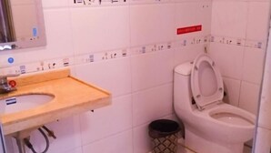 A small bathroom with a toilet, a sink, and a trash bin. - Yiting Hotel Loudi (Loudi)