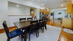 A modern kitchen with wooden cabinets, a built-in oven, and a microwave.