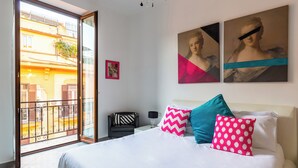 A bedroom with a bed, pillows, a nightstand, a lamp, and a painting on the wall. - Ferdinando Art House by Wonderful Italy (Naples)