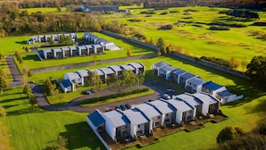 A modern hotel with multiple units, arranged in a linear fashion with a central courtyard. - Castlemartyr Holiday Lodges No 3 (2 Bed) (Castlemartyr)