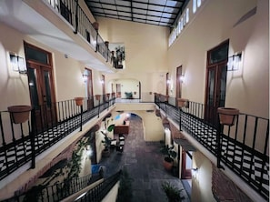 Experience the serene atmosphere of our central courtyard, surrounded by lush greenery and a beautifully designed walkway.
