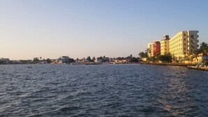 A waterfront hotel with multiple floors, a dock, and a calm sea. - Make it Your Home !!! (Street belize city)