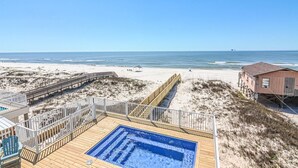 A beach view with a wooden deck, a small pool, and a beach house. - Beachfront House with Pool! 6 BR/6.5 Beachfront Paradise! (Gulf Shores)