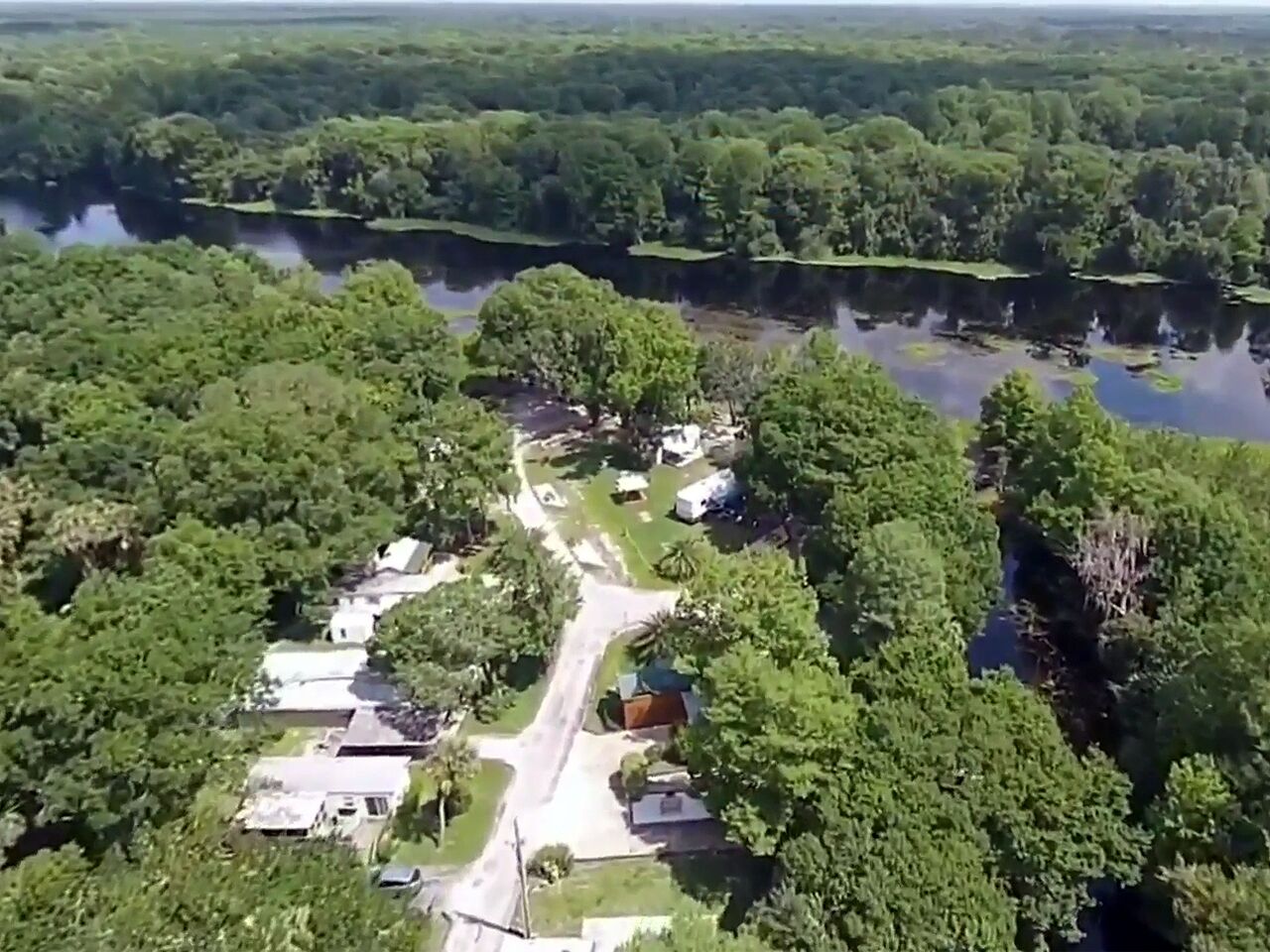 An aerial view of a residential area with houses and a road.