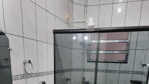 Ein Badezimmer mit Duschkabine, Toilette und Waschbecken.