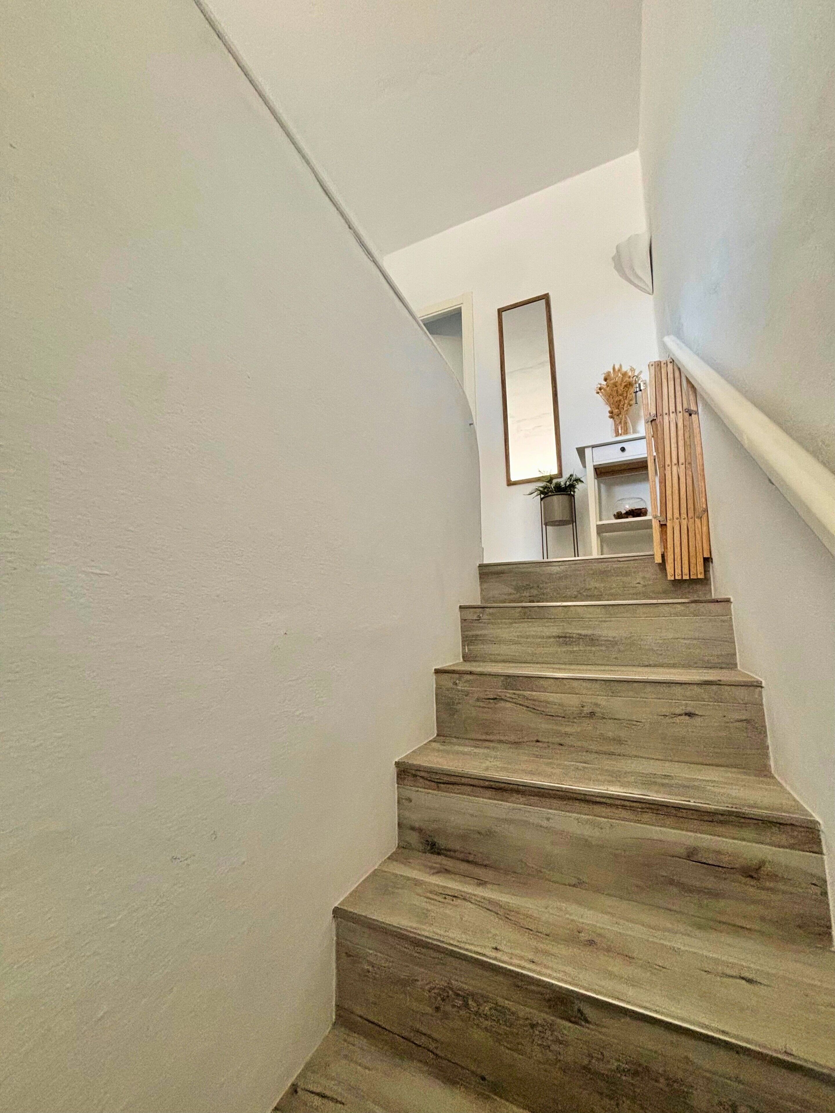 A staircase with wooden steps leading to a landing.