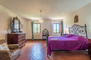 A bedroom with a bed, dresser, chair, and a window with curtains. - Apartment 'Villa Caselunghe' with Shared Pool, Wi-Fi and Air Conditioning (Siena)