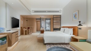 A modern hotel room with a bed, bedside table, TV, and a shower area. - Holiday Inn Resort Kanas Hemu by IHG (Burqin)