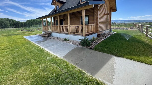 A log cabin with a porch, a small deck, and a view of the surrounding landscape. - Private Teton Basin Adventure Cabin! Hike, Ski, Fish, Close to Jackson (Tetonia)