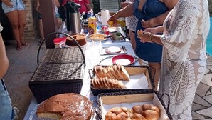 A buffet table with various food items and condiments.