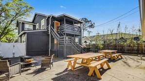 A modern house with a patio area featuring outdoor furniture and a barbecue grill. - 917- San Marco Sky Cottage, Pets OK, Near Arenas & Hospitals (Jacksonville)