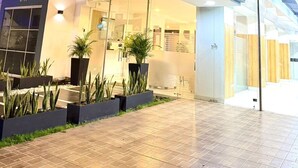 Ein Hotel mit modernem Design, darunter eine Glasfassade und ein einladender Bogen.