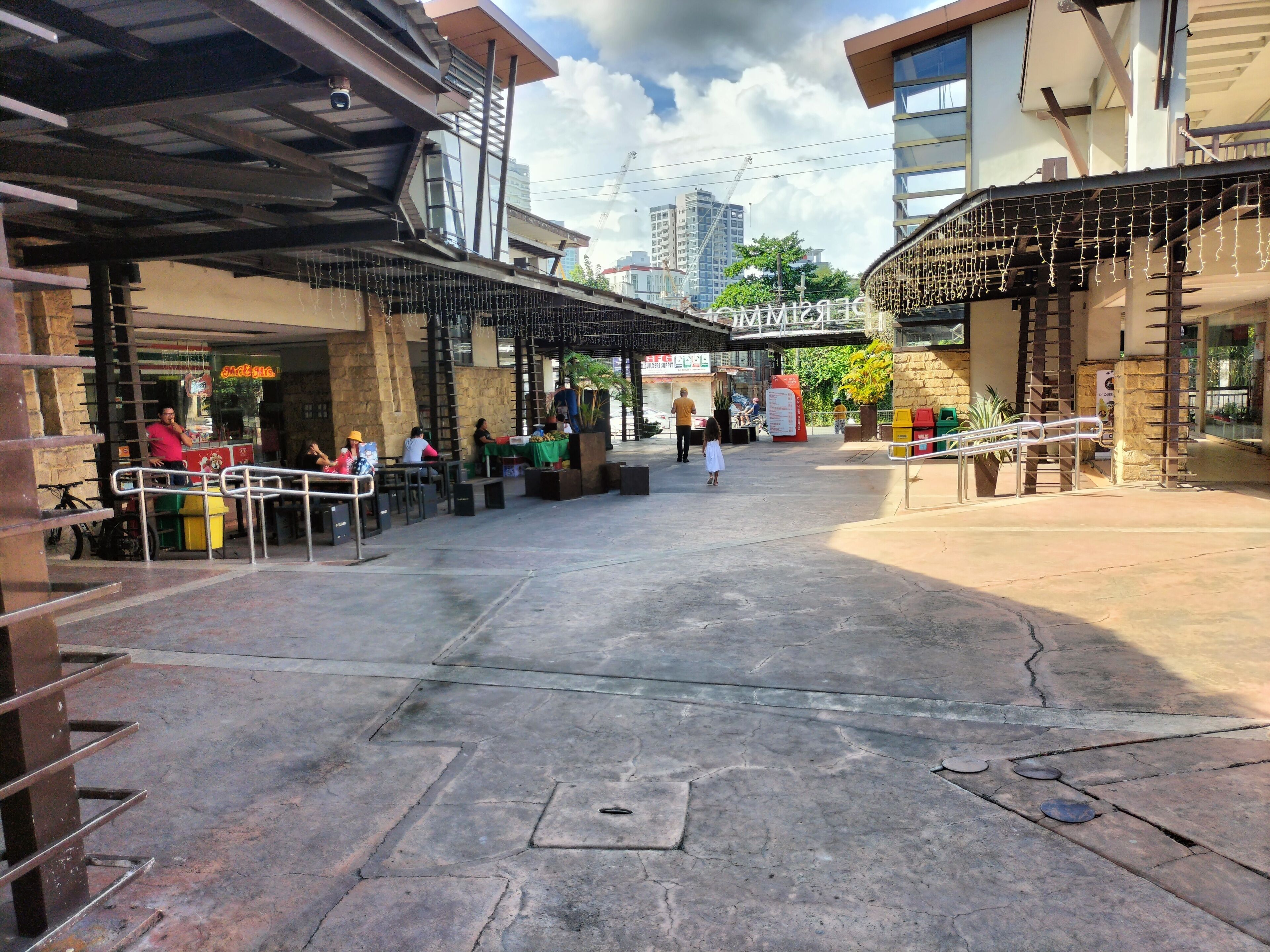 An outdoor area with a covered seating area, a staircase, and a building entrance.