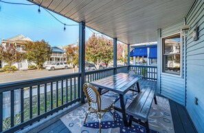 A porch with a wooden table and chairs, a railing, and a view of the street. - Pet-Friendly 3BR/2BA Condo w/ Fireplace in OCNJ North End (Ocean City)