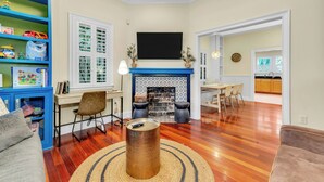 A living room with a fireplace, a television, and a bookshelf. - 1142- Bamboo Oasis, Great Entertaining, 1 Mile to Arenas, Pet & Family Friendly (Jacksonville)