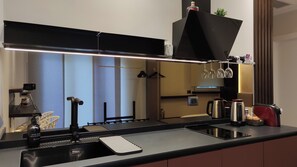 Fridge, stovetop, dishwasher, coffee/tea maker