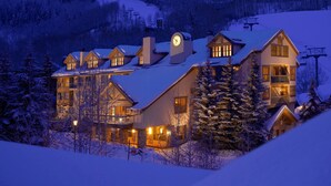 A large lodge with multiple buildings, a clock tower, and a ski lift in the background. - Deluxe King Room at Stunning Complex with Sauna (Beaver Creek)