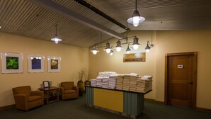 A fitness center with a reception desk, chairs, and a wall with framed pictures. - Elegant + Bright Suite | Fireplace & Pool Access (Crested Butte)