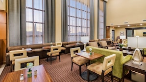 A hotel lobby with seating areas, a reception desk, and large windows. - 2 Bedroom | Free Breakfast. Indoor Pool (Longview)