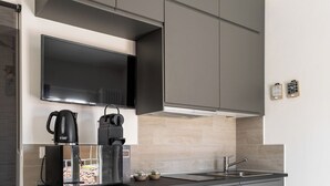 A modern kitchen with grey cabinets, a built-in microwave, and a coffee maker. - Appartamento vicino all'Orto Botanico by Wonderful Italy (Bologna)