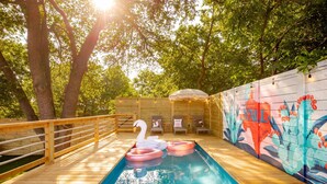 A wooden deck with a pool, swan floaties, and a mural. - Pool, Pickleball, Resort Backyard, 16min to Downtown - Modern Cowgirl (Austin)
