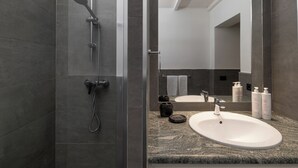 A modern bathroom with a shower, sink, and large mirror. - Bonaventura's House by Wonderful Italy (Olbia)
