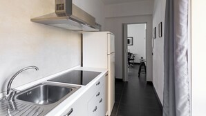 A modern kitchen with stainless steel appliances, a built-in sink, and a sleek countertop. - Bonaventura's House by Wonderful Italy (Olbia)