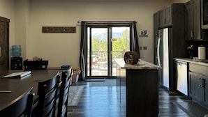 A modern kitchen with dark wood cabinets, a stainless steel refrigerator, and a large water dispenser. - Pet Friendly Outdoor Enthusiast's Retreat. Walk to Lake Dillon! (Dillon)