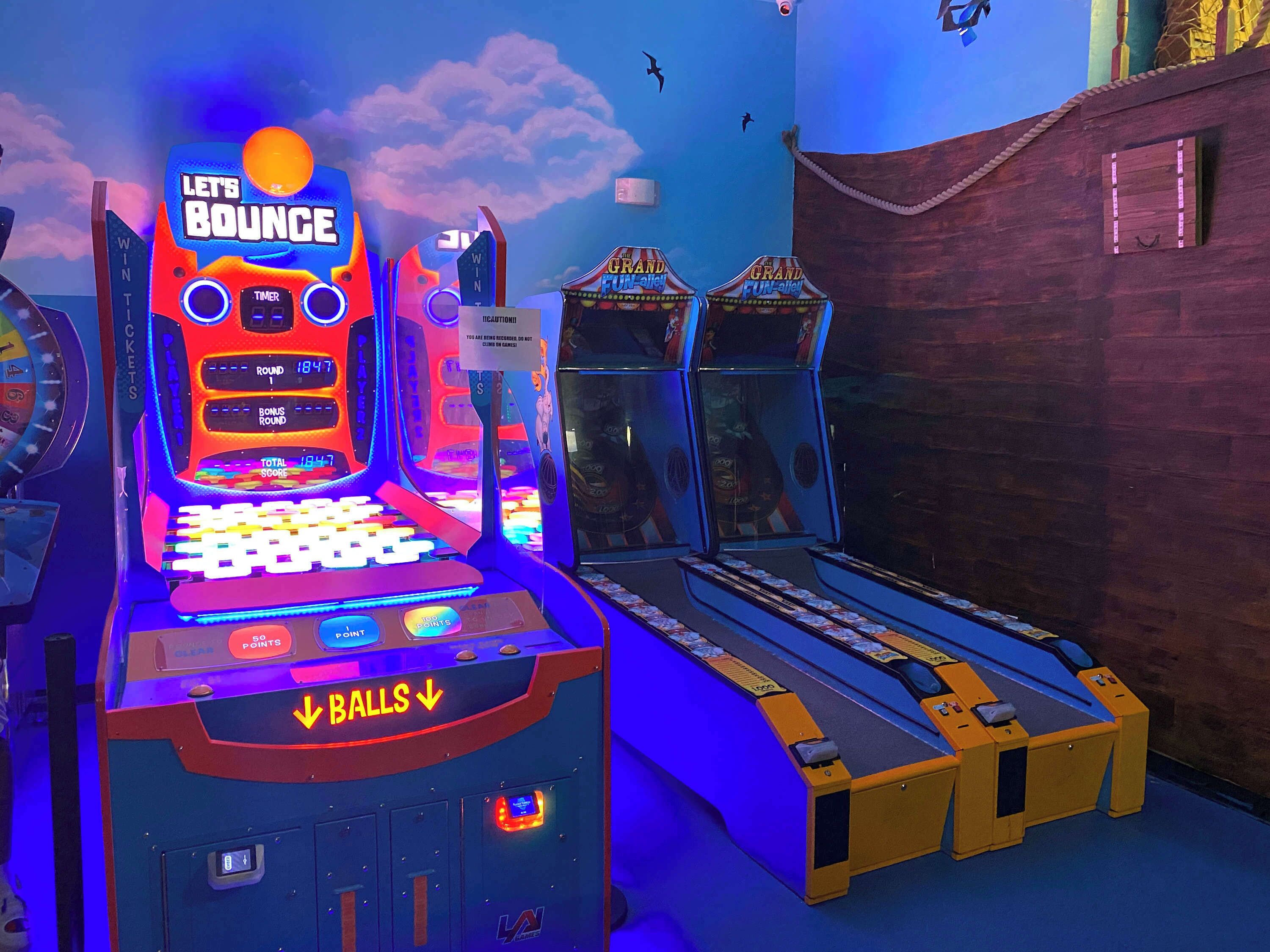 A pinball machine with a 'Let's Bounce' sign, a timer, and a score display.