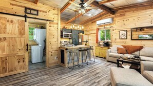 A cozy cabin interior with a kitchen, dining area, and living room. - Cozy Cove Cabin The Perfect Ozark Retreat! (Camdenton)