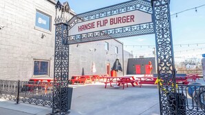 A metal archway with the text "HANSIE FLIP BURGER" above a building entrance. - Arkstone Retreat 2 - 4 minutes from the Ark! (Williamstown)