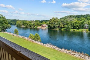 A river with a wooden deck in the foreground and a house on the opposite bank. - Peaceful Lakeview Escape - For 6 (Branson)