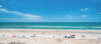 Updated direct oceanfront condo with a private balcony, heated pool, and beach access