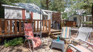 A deck with outdoor furniture, a covered area, and a mobile home. - Mobile Home on Family Campsite with Pools (Saint-Jean-de-Monts)