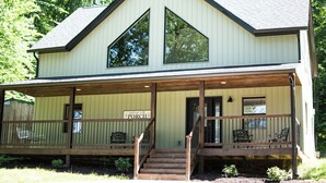 A two-story building with a porch, wooden steps, and a sign that reads "Welcome to the Porch." - Updated Getaway in the hills of southern Indiana. Minutes from Starve Hollow SRA (Vallonia)