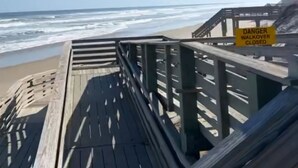 A wooden boardwalk leading to a beach with a 'DANGER WALKOVER CLOSED' sign. - New Condo, Sleeps 6, 3 Bedroom, Beach Access, Community Pool & Private Cabanas. (Corolla)