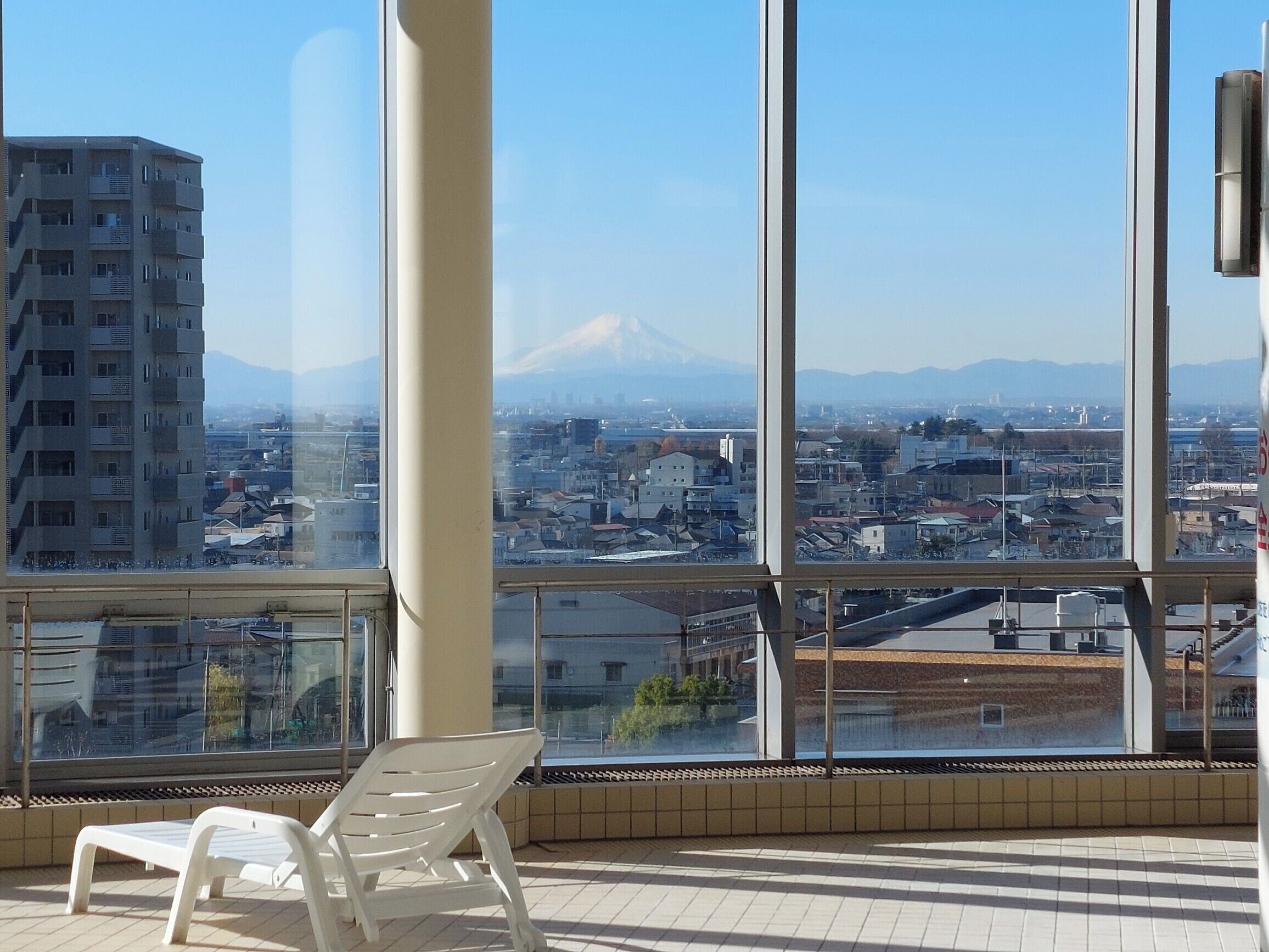 Un balcón con vista a un paisaje urbano y una montaña.