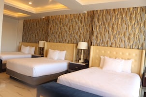 Deluxe Triple Room | Minibar, in-room safe, desk, laptop workspace